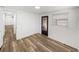 Bright bedroom area featuring wood-look floors and an exterior door at 3043 Sego Ln, Lakeland, FL 33801