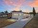 Charming single-story home featuring a well-manicured lawn, and a private carport at 3043 Sego Ln, Lakeland, FL 33801