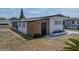 Angle view of the home showing the unique wood slat and manicured landscaping at 3043 Sego Ln, Lakeland, FL 33801