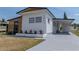 View of the front of the home highlighting a new driveway and landscaping at 3043 Sego Ln, Lakeland, FL 33801