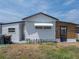 Exterior view featuring white siding, black trim, awning, and modern door at 3043 Sego Ln, Lakeland, FL 33801