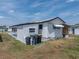 Exterior view of home with white siding, black trim, and well-maintained lawn at 3043 Sego Ln, Lakeland, FL 33801