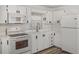 Bright kitchen with white cabinets, modern appliances, and plenty of counter space at 3043 Sego Ln, Lakeland, FL 33801