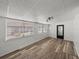 Spacious living area filled with natural light, vinyl floors and white walls; a blank canvas awaiting your personal touch at 3043 Sego Ln, Lakeland, FL 33801