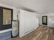 This area has an efficient water heater and storage closet, complemented by vinyl flooring and bright white walls at 3043 Sego Ln, Lakeland, FL 33801
