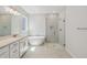 Elegant bathroom featuring a soaking tub, walk-in shower, and double vanity at 3102 Voyager Ave, St Cloud, FL 34771