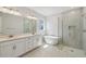 Spa-like bathroom with a soaking tub, walk-in glass shower, and double vanity at 3102 Voyager Ave, St Cloud, FL 34771