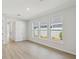 Bedroom with wood-look floors and large windows with views of the outdoors at 3102 Voyager Ave, St Cloud, FL 34771