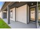 A modern home exterior with gray siding, dark trim, and covered porch at 3102 Voyager Ave, St Cloud, FL 34771