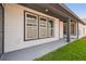 A well-lit, bright home exterior featuring white siding and black trim on windows and accents at 3102 Voyager Ave, St Cloud, FL 34771