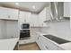 Modern kitchen with stainless steel appliances, white cabinetry, and white subway tile backsplash at 3102 Voyager Ave, St Cloud, FL 34771