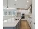 Modern kitchen with white cabinets, stainless steel appliances, and a large island, blending style and functionality at 3102 Voyager Ave, St Cloud, FL 34771