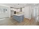 Stylish kitchen with a gray island, white cabinets, and stainless steel appliances, designed for modern living at 3102 Voyager Ave, St Cloud, FL 34771