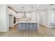Well-lit kitchen with a large central island, modern appliances, and ample storage space, ideal for cooking at 3102 Voyager Ave, St Cloud, FL 34771