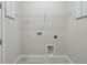 Neutral laundry room has tile flooring and is equipped with overhead shelf and utility connections at 3102 Voyager Ave, St Cloud, FL 34771