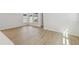 Bright, open living room with wood-look flooring, large windows and neutral paint at 3102 Voyager Ave, St Cloud, FL 34771