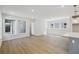 Open-concept living space featuring wood-look floors, natural light, and a modern design at 3102 Voyager Ave, St Cloud, FL 34771