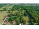 Aerial view of property surrounded by lush greenery and horse pastures, bordered by a vibrant red line at 7795 Sw 72Nd Ct, Ocala, FL 34476