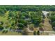 Aerial view of large property surrounded by lush greenery, bordered by a vibrant red line at 7795 Sw 72Nd Ct, Ocala, FL 34476