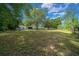 Expansive backyard with mature trees and wooden fence at 7795 Sw 72Nd Ct, Ocala, FL 34476