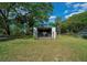 Barn for farm equipment, with secure gating and ample storage space, nestled in a lush green landscape, offering practical utility at 7795 Sw 72Nd Ct, Ocala, FL 34476