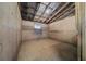 Barn interior, featuring concrete walls, a small window, and wood flooring, providing a secure and functional agricultural space at 7795 Sw 72Nd Ct, Ocala, FL 34476
