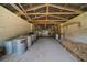 Interior of a barn with stalls and storage, featuring a concrete floor and rustic wooden beams at 7795 Sw 72Nd Ct, Ocala, FL 34476