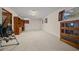 Spacious basement with neutral carpeting, storage cabinets, and outside access through a door and windows at 7795 Sw 72Nd Ct, Ocala, FL 34476