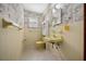 Quaint yellow bathroom features vintage fixtures, patterned wallpaper, and a functional layout at 7795 Sw 72Nd Ct, Ocala, FL 34476