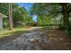 View of a barn on the property with a dirt driveway at 7795 Sw 72Nd Ct, Ocala, FL 34476