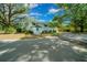 Charming two-story home with white siding, a green roof, and a well-manicured lawn at 7795 Sw 72Nd Ct, Ocala, FL 34476