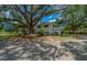 Charming two-story home surrounded by mature trees, lush greenery, and a well-maintained yard at 7795 Sw 72Nd Ct, Ocala, FL 34476