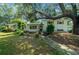 Charming two-story home with well-maintained landscaping, lush plants, and a stone walkway at 7795 Sw 72Nd Ct, Ocala, FL 34476