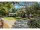 Charming single-story home with mature trees, a lush front lawn, and a circular driveway at 7795 Sw 72Nd Ct, Ocala, FL 34476