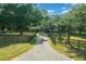 Long private drive to charming home surrounded by mature trees and fenced pasture land at 7795 Sw 72Nd Ct, Ocala, FL 34476