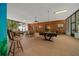 Spacious game room with wood paneling and a pool table, great for entertaining at 7795 Sw 72Nd Ct, Ocala, FL 34476