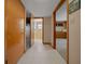 Hallway featuring doorways to the bathroom and living area with neutral walls and tile flooring at 7795 Sw 72Nd Ct, Ocala, FL 34476