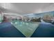 Indoor pool area featuring custom mural and ample sunlight, offering a serene and private recreational space year-round at 7795 Sw 72Nd Ct, Ocala, FL 34476