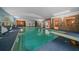 Large indoor swimming pool with diving board and muraled walls at 7795 Sw 72Nd Ct, Ocala, FL 34476