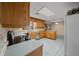 Bright kitchen with oak cabinets, stainless steel appliances, and white tiled flooring at 7795 Sw 72Nd Ct, Ocala, FL 34476