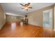 Spacious living room with wood floors, neutral walls, and an attached bath at 7795 Sw 72Nd Ct, Ocala, FL 34476