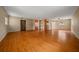 Spacious living room with hardwood floors, a ceiling fan, and access to a closet and other rooms at 7795 Sw 72Nd Ct, Ocala, FL 34476