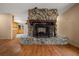 Unique stone fireplace with wooden beam mantel as a focal point in the living room at 7795 Sw 72Nd Ct, Ocala, FL 34476