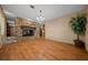 Cozy living room showcasing gorgeous wood floors, stone fireplace, and natural light at 7795 Sw 72Nd Ct, Ocala, FL 34476