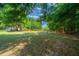 Picturesque pasture features mature trees and a durable metal fence, enhancing the property's appeal for equestrian enthusiasts at 7795 Sw 72Nd Ct, Ocala, FL 34476