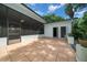 Covered patio with tile flooring and access to the backyard and exterior bathroom at 7795 Sw 72Nd Ct, Ocala, FL 34476