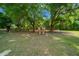 Spacious property with an open metal gate and lush green lawn at 7795 Sw 72Nd Ct, Ocala, FL 34476