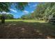 Open land and green spaces featuring mature trees and white barn at 7795 Sw 72Nd Ct, Ocala, FL 34476