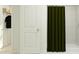 Bright bathroom featuring white tiling, shower with green curtain, and closet at 3502 Kimbrough Dr, Lake Wales, FL 33859