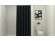 Bathroom featuring a black shower curtain, black and white artwork, and a white commode at 3506 Kimbrough Dr, Lake Wales, FL 33859